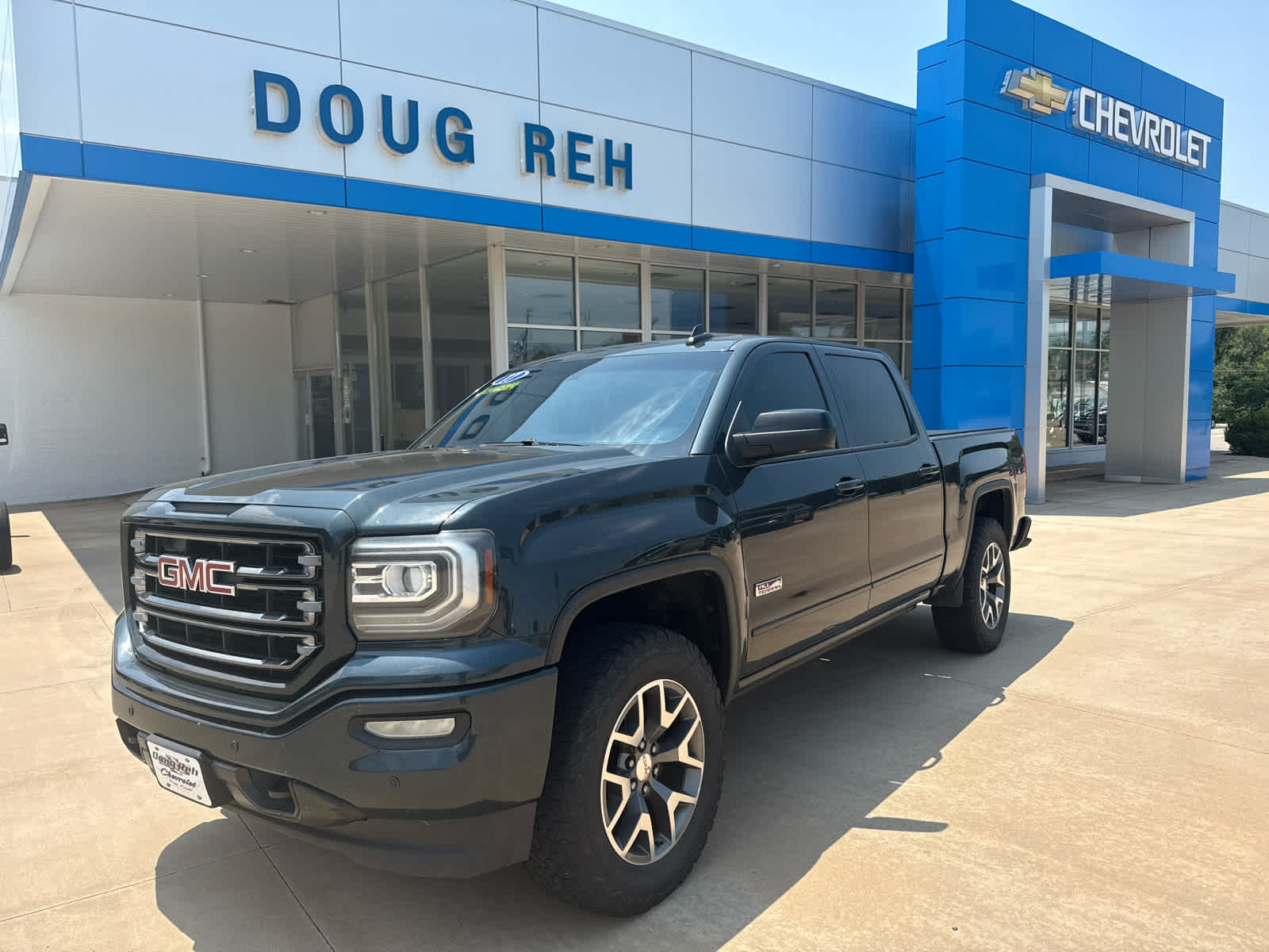 2017 GMC Sierra 1500 SLT in Dark Slate Metallic — front three-quarter view