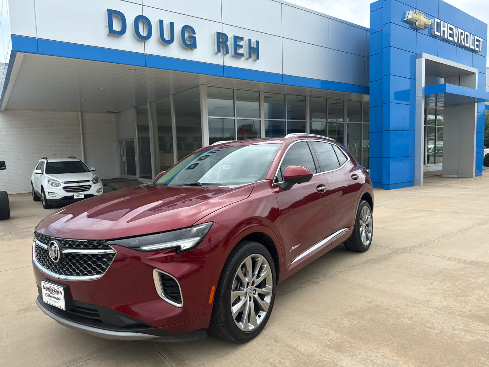2022 Buick Envision Avenir in Cinnabar Metallic — front three-quarter view